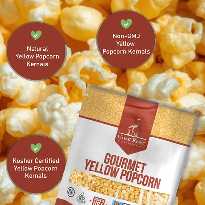 A bag of Great River Milling Gourmet Yellow Popcorn Kernels is displayed against a backdrop of popped yellow popcorn. The packaging highlights its natural, non-GMO, and kosher certifications