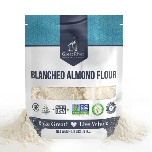 Blanched Almond Flour bag from Great River Milling with almond flour spilling onto a white surface