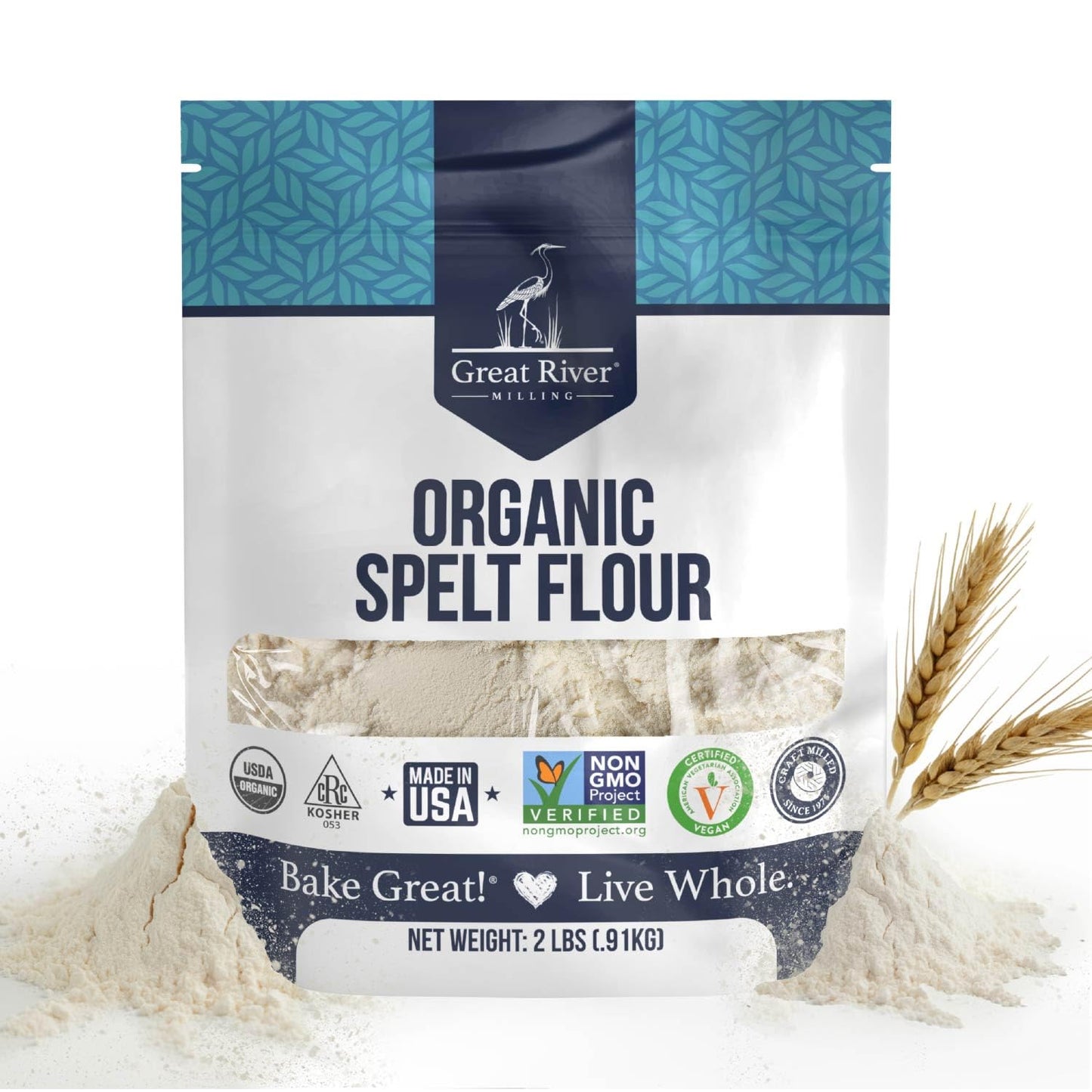A 2 lb bag of Organic Spelt Flour featuring certification logos, illustrations of wheat stalks, and a touch of spilled flour around the package. This ancient grain flour comes in a blue and white bag displaying product details—an ideal choice for anyone looking for premium organic spelt flour.