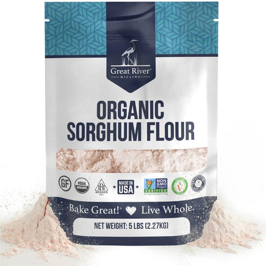 A 25 lb bag of Great River Milling Organic Sorghum Flour with a blue and white design, featuring various certification logos and "Bake Great! Live Whole" slogan