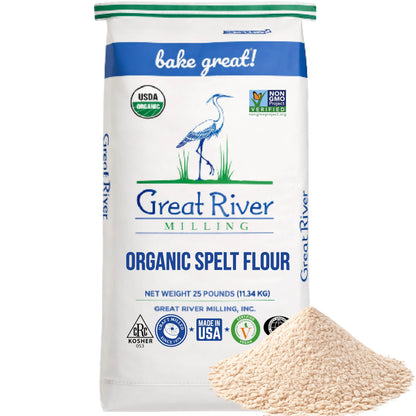 A 25-pound bag of Organic Spelt Flour, certified USDA Organic, Kosher, and Non-GMO. This premium bulk ancient wheat flour is a nutritious choice for your kitchen, with a mound of organic spelt flour shown in front of the bag.