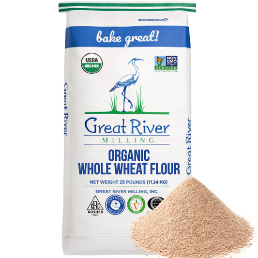 Organic Whole Wheat Flour bag by Great River Milling with a pile of whole grain flour