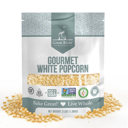 Great River Milling Gourmet White Popcorn Kernels in a 3 lb bag, featuring a clear window revealing the kernels. The packaging is adorned with various certification logos