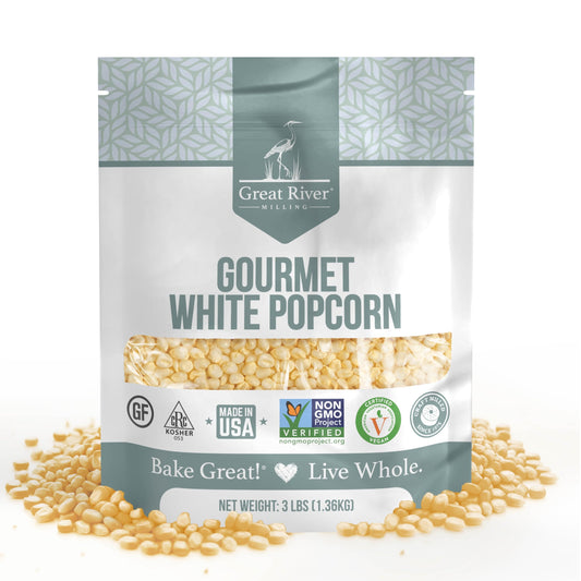 Great River Milling Gourmet White Popcorn Kernels in a 3 lb bag, featuring a clear window revealing the kernels. The packaging is adorned with various certification logos