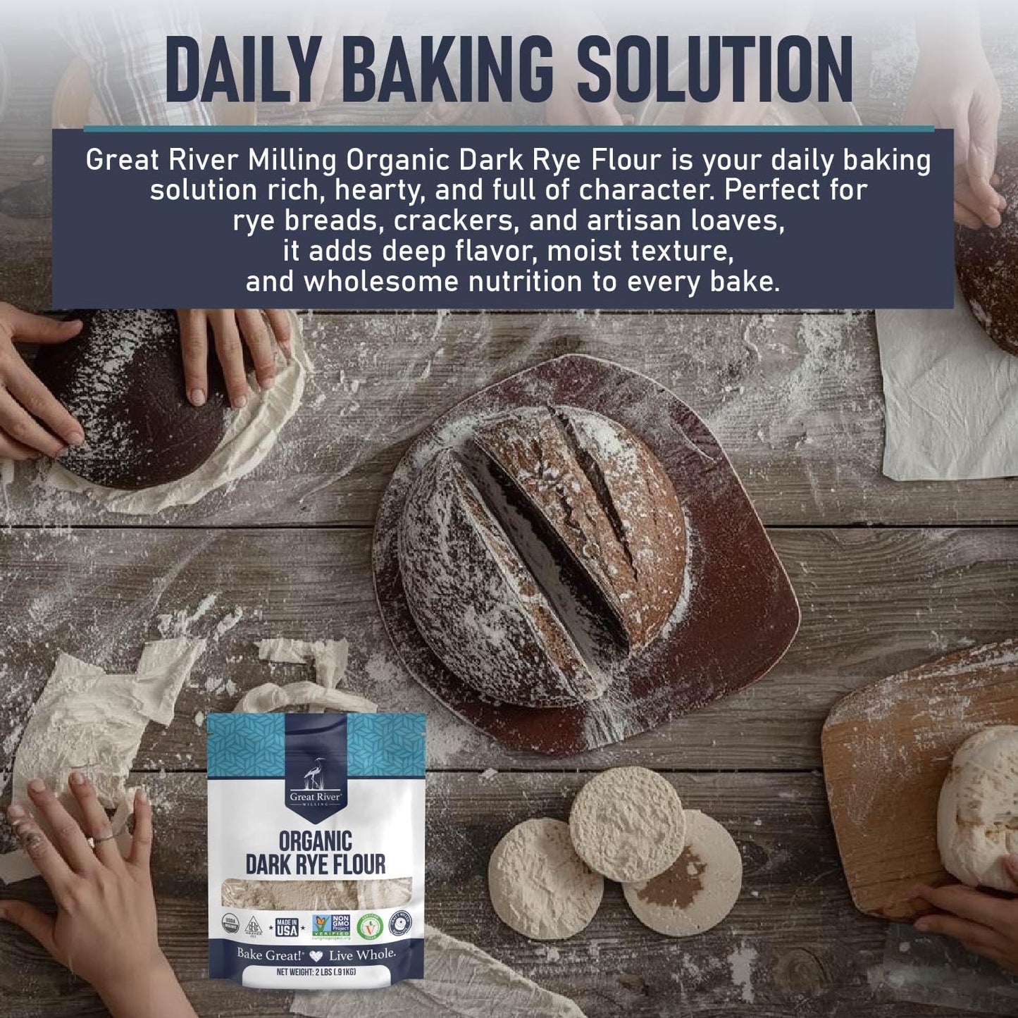 Great River Milling Organic Dark Rye Flour bag displayed on a rustic wooden table with hands preparing dough. The flour bag features a blue and white design with clear branding