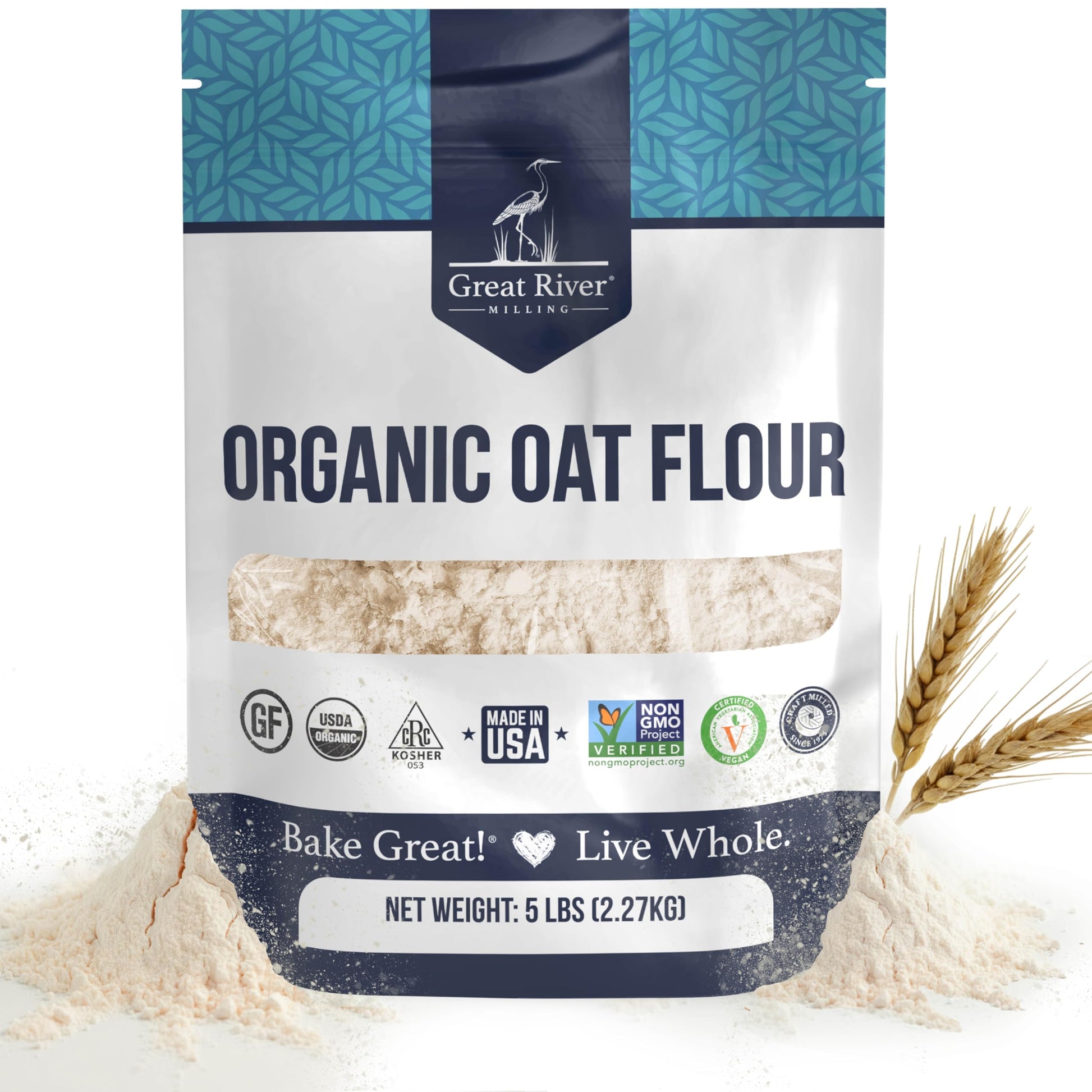 A 5 lb bag of Organic Oat Flour from Great River Milling, made with whole-grain oats and boasting several certifications, displays the “Bake Great! Live Whole.” slogan, shown alongside some organic oat flour and wheat stalks.