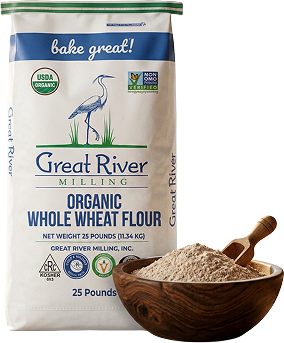 Organic whole wheat flour bag labeled Great River Milling with a wooden scoop holding pale flour